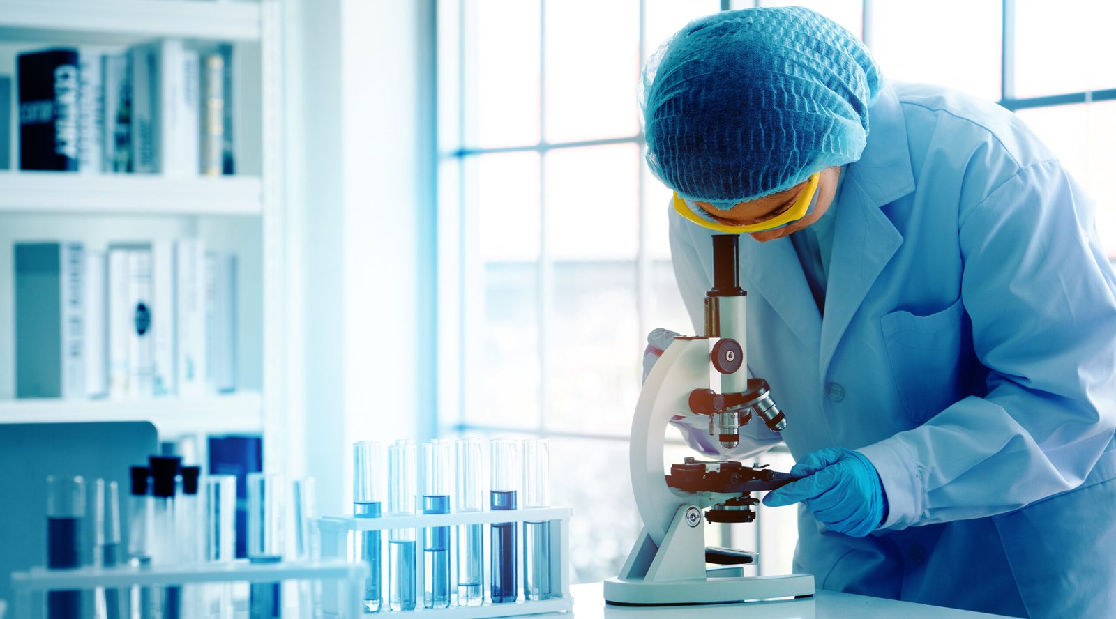 asian scientist or doctors use microscopes to test for the coronavirus (covid 19). or a new flu virus to save human life in the lab or hospital. successful in researching the treatment of patients